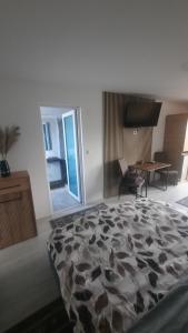 a room with a bed and a desk and a table at Casa Bon Relax , Rooms&Apartaments in Tuzla +41 photos