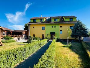 a large yellow house in a field of vines at Bořikovský Dvůr in Litovany