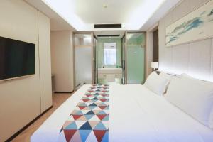 a hotel room with a large bed and a tv at HORIZON-boutique hotel in Chengdu +53 photos