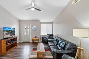 a living room with a couch and a table at Tranquility Place in Evans Head