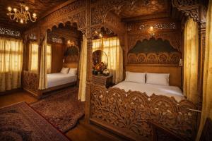a bedroom with an ornate bed and a mirror at Heritage Amina Group Of Houseboats in Srinagar