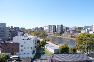 a view of a city with a river and buildings at Bears Building in Kumamoto