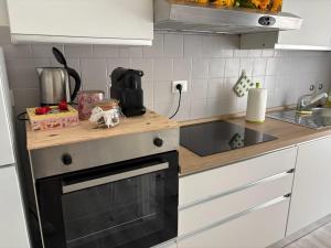 a kitchen with a counter top with a stove top oven at I Tulipani in Genoa