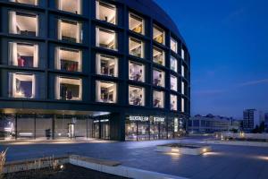a large building with many windows at night at STAGES HOTEL Prague, a Tribute Portfolio Hotel in Prague