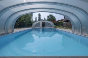 a swimming pool with an archway over it at Camping Seewiese in Pfedelbach