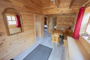 a log cabin with a table and a window at Camping Seewiese in Pfedelbach