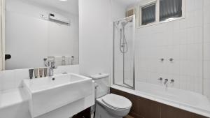 a bathroom with a toilet and a sink and a shower at Humffray 3 in Dinner Plain +12 photos