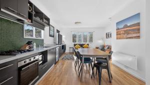 a kitchen with a table and a dining room at Humffray 3 in Dinner Plain