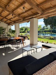 a patio with a couch and a table and chairs at Jesolo Luxury Suites in Jesolo