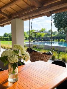 a wooden table with a vase of flowers on it at Jesolo Luxury Suites in Jesolo