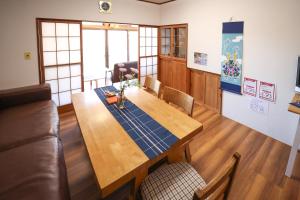 a dining room with a table and a couch at DON chan GuestHouse Nikko ,7 minutes walk from Imaichi Station in Nikko