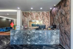 a lobby with a marble counter and a blue couch at Dedem Hotel Express-İstanbul Airport-Round Trip Airport Service in Arnavutköy