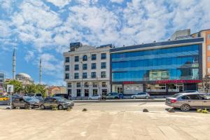 a city street with cars parked in front of a building at Dedem Hotel Express-İstanbul Airport-Round Trip Airport Service in Arnavutköy