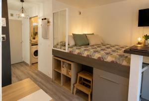 a living room with a large bed in a room at Studio Bord de Mer Résidence - Les Sablettes in La Seyne-sur-Mer