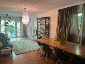 a living room with a wooden table and chairs at Garden Apartment in Baden-Baden