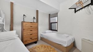a bedroom with two twin beds and a dresser at Snowgums 10 in Dinner Plain