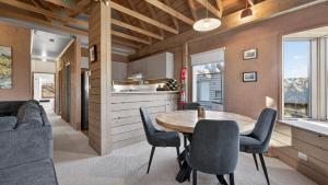 a kitchen and dining room with a table and chairs at Snowgums 10 in Dinner Plain