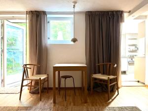 a dining room with a table and two chairs at Badklippan in Stockholm