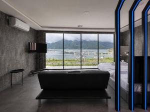 a bedroom with a bed and a large window at montevela glamping kintamani in Kubupenlokan