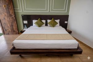 a bedroom with a large bed with green walls at Gharonda Manor-A Home Beyond Home -Best Luxury Budget Stay Near ISBT in Dehradun