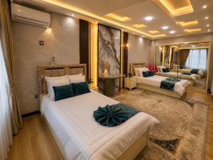 a bedroom with two beds and a living room at Royal Delegation Suite in Kabul +24 photos