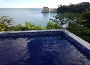 a swimming pool with a view of the water at Buan Badatgaeui Chuoek Pension in Buan