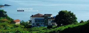 a house on a hill next to the ocean at Buan Badatgaeui Chuoek Pension in Buan +10 photos