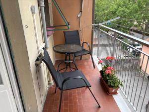 two chairs and a table on a balcony at I Tulipani in Genoa +23 photos