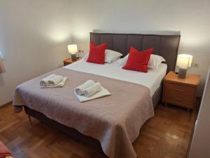 a bedroom with a large bed with two towels on it at Villa Fontana 2 in Sukošan