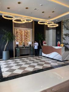 a man standing in a lobby with a checkered floor at studio MA-DE cozy Bacolod City in Bacolod +62 photos