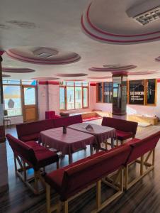 a dining room with tables and chairs in a building at Pachamama Hotels- Vashisht in Manāli