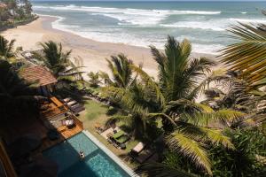 an overhead view of a beach with a pool and palm trees at Coast 67 Boutique Hotel in Ahangama +48 photos