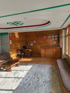 an empty room with a table and a desk at Pachamama Hotels- Vashisht in Manāli +48 photos