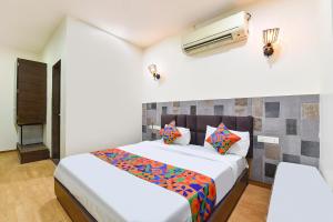 a bedroom with a bed and a air conditioner at FabHotel Harsh Paradise - Malviya Nagar in Jaipur