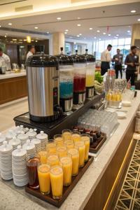 a buffet line with many glasses of orange juice at The Blue House in Jodhpur