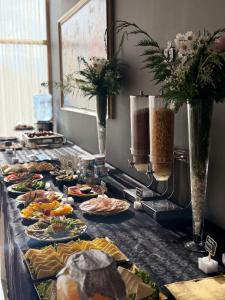 a buffet with many plates of food on a table at Balkan Crest Resort in Tirana