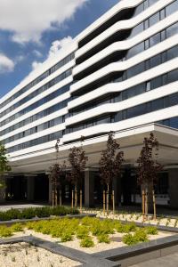 a large building with trees in front of it at Житомир by Optima in Zhytomyr