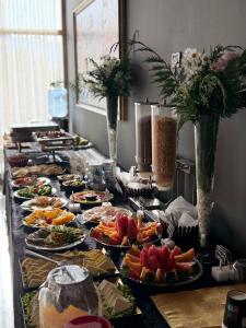 a buffet with many plates of food on a table at Balkan Crest Resort in Tirana +14 photos