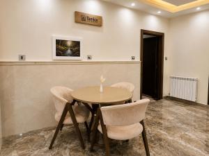 a dining room with a table and chairs at Royal Delegation Suite in Kabul