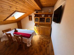 a dining room with a table and a television in a room at Sara`s Guesthouse Bled in Bled