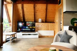 a living room with a television and a table at A frame Svetosavska bajka in Lisice
