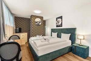 a bedroom with a large bed with white sheets at BERG & BERG Hotel - Hellbühl Self-Check-in in Hellbühl