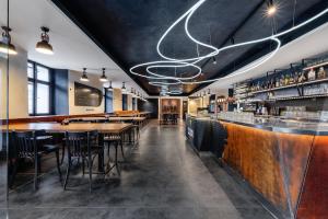 a restaurant with a bar with wooden tables and chairs at Hotel Restaurant Darwin in Prague