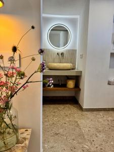 a bathroom with a sink and a mirror at Vida Lenta Boutique Finca in Alora