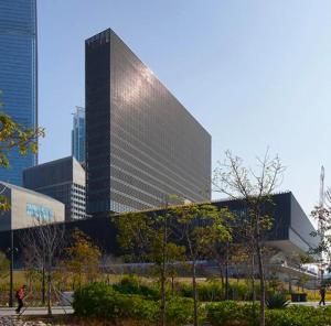 a tall glass building in front of a city at Dorsett Mongkok, Hong Kong in Hong Kong