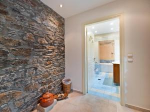a stone wall in a hallway with a bathroom at Neptune Suite Sounio in Sounio +33 photos