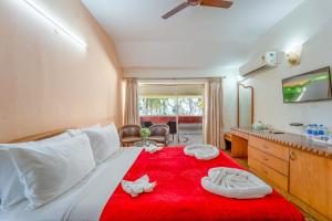 a bedroom with a bed with two towels on it at Calangute Residency in Calangute +44 photos