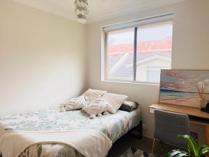 a bedroom with a bed and a window at Cozy Bondi ROOM - Beach life and Local Host! Free Parking in Sydney