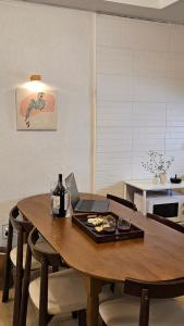a dining room table with a laptop computer on it at sinae stayG in Seoul +39 photos
