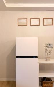 a white refrigerator in a room with a table at sinae stayG in Seoul